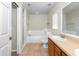 Main bathroom with tub, shower, tile floor, and vanity at 6495 Fall St, St Cloud, FL 34771