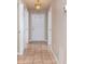 Bright foyer featuring tile flooring, closet space, and a modern light fixture at 6495 Fall St, St Cloud, FL 34771