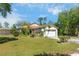 Lawn view of this home with a two-car garage, pretty landscaping, and lots of curb appeal at 6495 Fall St, St Cloud, FL 34771