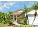 Close up of the front of this home with tropical landscaping, lots of light, and an easy walkway at 6495 Fall St, St Cloud, FL 34771