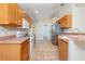 Open concept kitchen featuring light colored cabinets, stainless steel appliances, and tile floors at 6495 Fall St, St Cloud, FL 34771