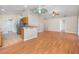 Open concept living room and kitchen with hardwood floors, stainless steel appliances, and lots of natural light at 6495 Fall St, St Cloud, FL 34771