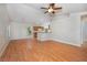Bright living room featuring hardwood floors, lots of natural light, and a ceiling fan at 6495 Fall St, St Cloud, FL 34771