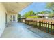 View of a covered patio with a wooden walkway, and backyard with partial fence at 6495 Fall St, St Cloud, FL 34771