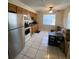 Functional kitchen with white appliances, ample cabinet space, and tile flooring at 723 Michigan Ct # 3, St Cloud, FL 34769