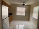Bright kitchen area featuring white tiled floors, neutral wall color, and ceiling fan at 723 Michigan Ct # 3, St Cloud, FL 34769