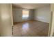 Neutral living room with tiled floors, bright window, and entry door at 723 Michigan Ct # 3, St Cloud, FL 34769