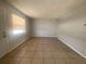 Neutral living room featuring tiled floors and a bright window at 723 Michigan Ct # 3, St Cloud, FL 34769