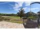 Stunning backyard view of a lush green golf course from a comfy hanging chair at 7570 Excitement Dr, Reunion, FL 34747