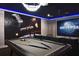 Well-appointed basement featuring a pool table, movie screen, and immersive thematic elements at 7570 Excitement Dr, Reunion, FL 34747