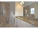 Bathroom features granite counters, double sinks, separate shower, and tile floors at 7570 Excitement Dr, Reunion, FL 34747