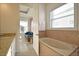 Bathroom featuring separate soaking tub, double sinks, and great light at 7570 Excitement Dr, Reunion, FL 34747