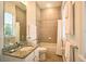 Bathroom featuring granite countertop, tiled walls, and natural lighting at 7570 Excitement Dr, Reunion, FL 34747
