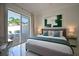 Bright bedroom with sliding glass doors to patio, features modern decor and luxury furnishings at 7570 Excitement Dr, Reunion, FL 34747