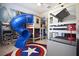Unique bedroom features a built-in bunk bed, slide, Marvel themed wallpaper, and an arcade machine at 7570 Excitement Dr, Reunion, FL 34747