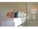Elegant bedroom with padded headboard, mirrored nightstand, and stylish accent pillows at 7570 Excitement Dr, Reunion, FL 34747