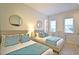 Bright bedroom with twin beds, decorative mirrors, and a comfortable, clean aesthetic at 7570 Excitement Dr, Reunion, FL 34747