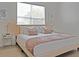 Bright bedroom featuring a queen bed, white linens, pink accents, and modern lamps at 7570 Excitement Dr, Reunion, FL 34747