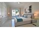 Bright bedroom with sliding glass doors to patio, features modern decor and luxury furnishings at 7570 Excitement Dr, Reunion, FL 34747