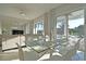 Bright dining room features a modern glass table and seamless access to the outdoor patio area at 7570 Excitement Dr, Reunion, FL 34747
