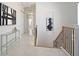 Bright hallway with white walls, artwork, and staircase at 7570 Excitement Dr, Reunion, FL 34747
