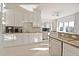 Bright kitchen showcases modern white cabinets, granite countertops, and stainless steel appliances at 7570 Excitement Dr, Reunion, FL 34747