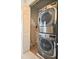 Modern laundry room featuring stacked washer and dryer at 7570 Excitement Dr, Reunion, FL 34747
