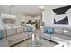Inviting living room with stylish furnishings, including plush sofas and a round glass coffee table at 7570 Excitement Dr, Reunion, FL 34747