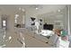 Open living space with a modern kitchen, comfortable seating, and large windows with bright, natural light at 7570 Excitement Dr, Reunion, FL 34747