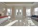 Bright main bedroom boasts beautiful natural light, a seating area, and doors to a balcony at 7570 Excitement Dr, Reunion, FL 34747