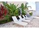Lush landscaping complements the cozy lounge chairs for ultimate relaxation in this backyard at 7570 Excitement Dr, Reunion, FL 34747