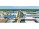 Aerial view of a city with commercial buildings and tree-lined streets on a clear, sunny day at 815 Kentucky Ave, St Cloud, FL 34769