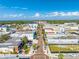 Aerial view of a city with commercial buildings and tree-lined streets on a clear, sunny day at 815 Kentucky Ave, St Cloud, FL 34769