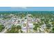 Aerial view of a city, with its tree-lined streets, commercial buildings, and the expanse of the lake at 815 Kentucky Ave, St Cloud, FL 34769