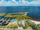 Wide aerial view of lakefront park with beach, splash pad, and playground, marina nearby at 815 Kentucky Ave, St Cloud, FL 34769