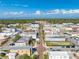 Aerial view of a city with commercial buildings and tree-lined streets on a clear, sunny day at 815 Kentucky Ave, St Cloud, FL 34769