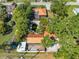 Overhead view of home featuring a pool, outbuildings, mature trees, brown metal roofs and a well-maintained surrounding landscape at 815 Kentucky Ave, St Cloud, FL 34769