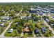 An aerial view showcases the home's location in a community surrounded by lush greenery, homes and businesses at 815 Kentucky Ave, St Cloud, FL 34769