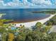Beautiful lakefront featuring sandy beach, lush park with mature trees, and playground at 815 Kentucky Ave, St Cloud, FL 34769