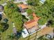 Aerial view of a home showcasing its brown metal roof, pool, outbuildings and lush green landscaping at 815 Kentucky Ave, St Cloud, FL 34769