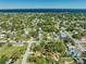 Aerial view of a residential neighborhood with lush greenery and water views; property is marked by a pin at 815 Kentucky Ave, St Cloud, FL 34769
