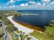 Scenic aerial view of waterfront park and recreation area featuring sandy beach, volleyball court, and a lake at 815 Kentucky Ave, St Cloud, FL 34769