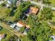 Aerial view of a residential house with a brown roof, mature landscaping, and a serene backyard pool area at 815 Kentucky Ave, St Cloud, FL 34769
