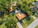 Aerial view of the property, showcasing the home, brick driveway, pool area, and lush greenery at 815 Kentucky Ave, St Cloud, FL 34769