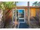 Back exterior of home with wood paneling, sliding glass doors providing pool views, and a garden area at 815 Kentucky Ave, St Cloud, FL 34769
