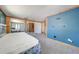 Bedroom features carpet flooring, closet with mirrored doors, and blue accent wall at 815 Kentucky Ave, St Cloud, FL 34769