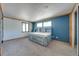 Bedroom featuring carpet flooring, blue accent wall, and custom built-in bed with drawers at 815 Kentucky Ave, St Cloud, FL 34769