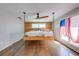 Bright bedroom features a hanging bed in front of wood accent wall and light-filled windows at 815 Kentucky Ave, St Cloud, FL 34769