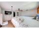 Spacious bedroom featuring a unique hanging bed with ceiling fan and mounted television at 815 Kentucky Ave, St Cloud, FL 34769