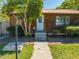 Charming home with a well-manicured lawn, stone walkway and a metal roof, enhancing its curb appeal at 815 Kentucky Ave, St Cloud, FL 34769
